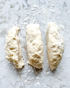 process of splitting dough into three separate pieces