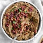 completed Spicy Lentil Kalamata Dip in a white bowl against a white background