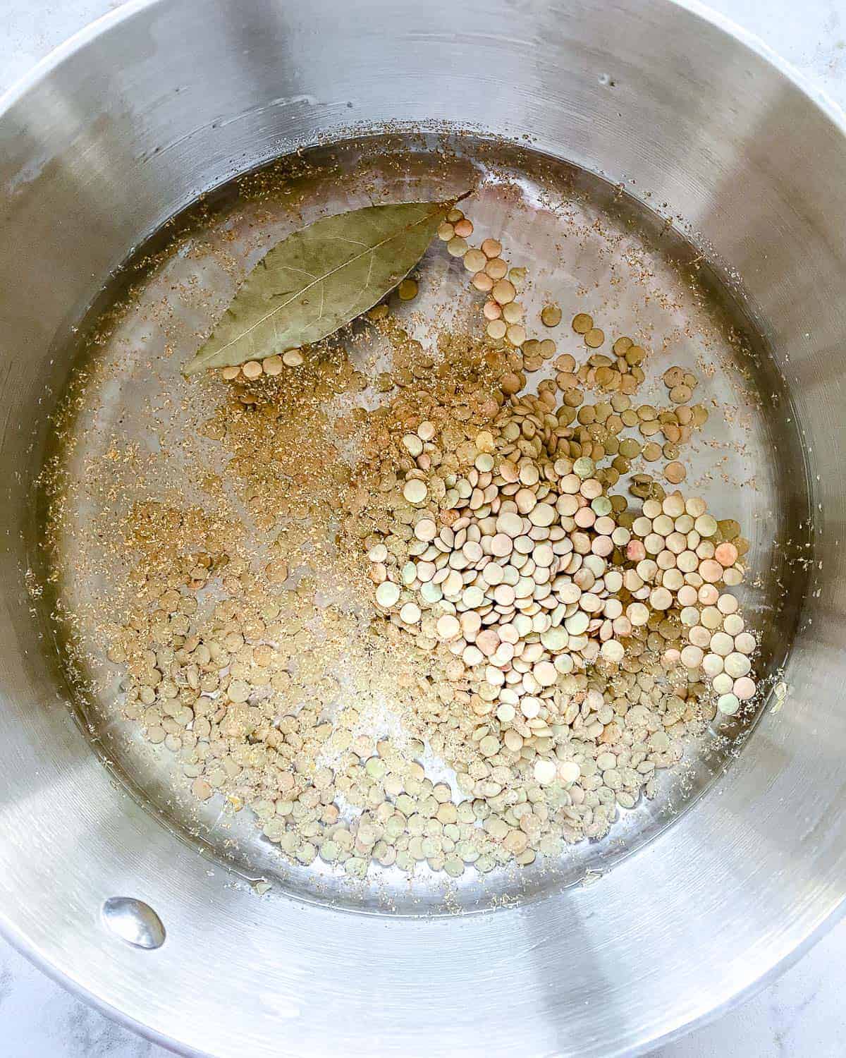 process of putting ingredients into stainless steel bowl