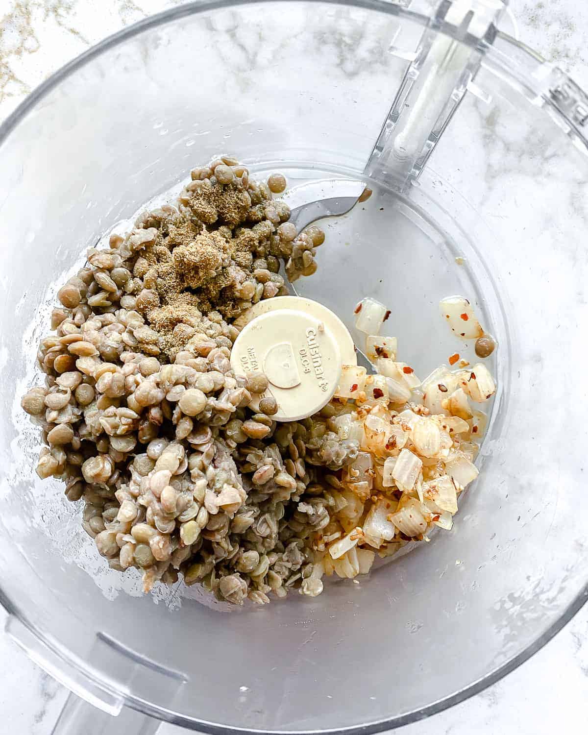 process of adding ingredients to food processor
