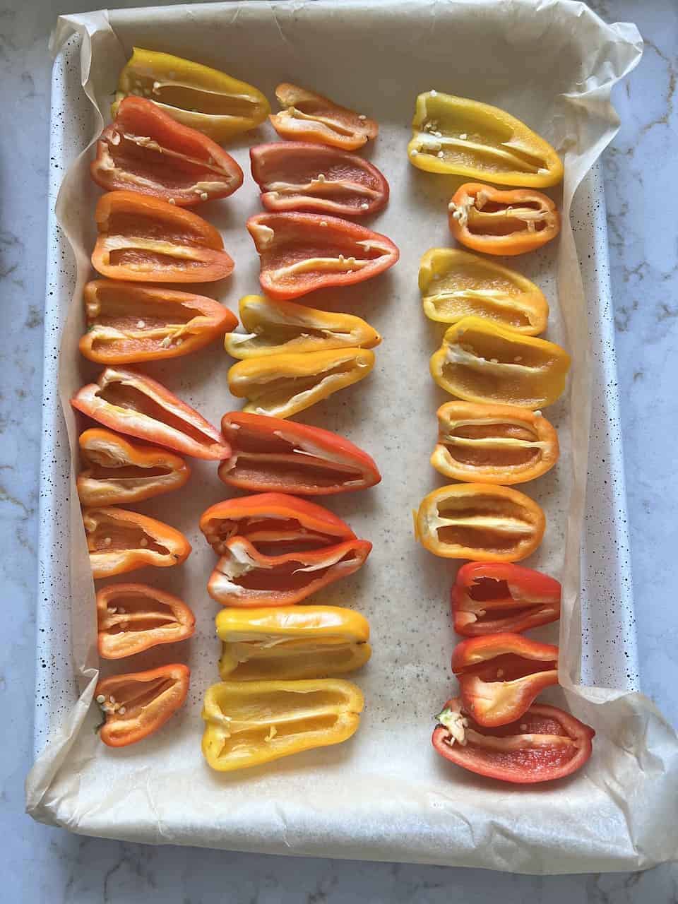 process of halved sweet peppers against a white surface