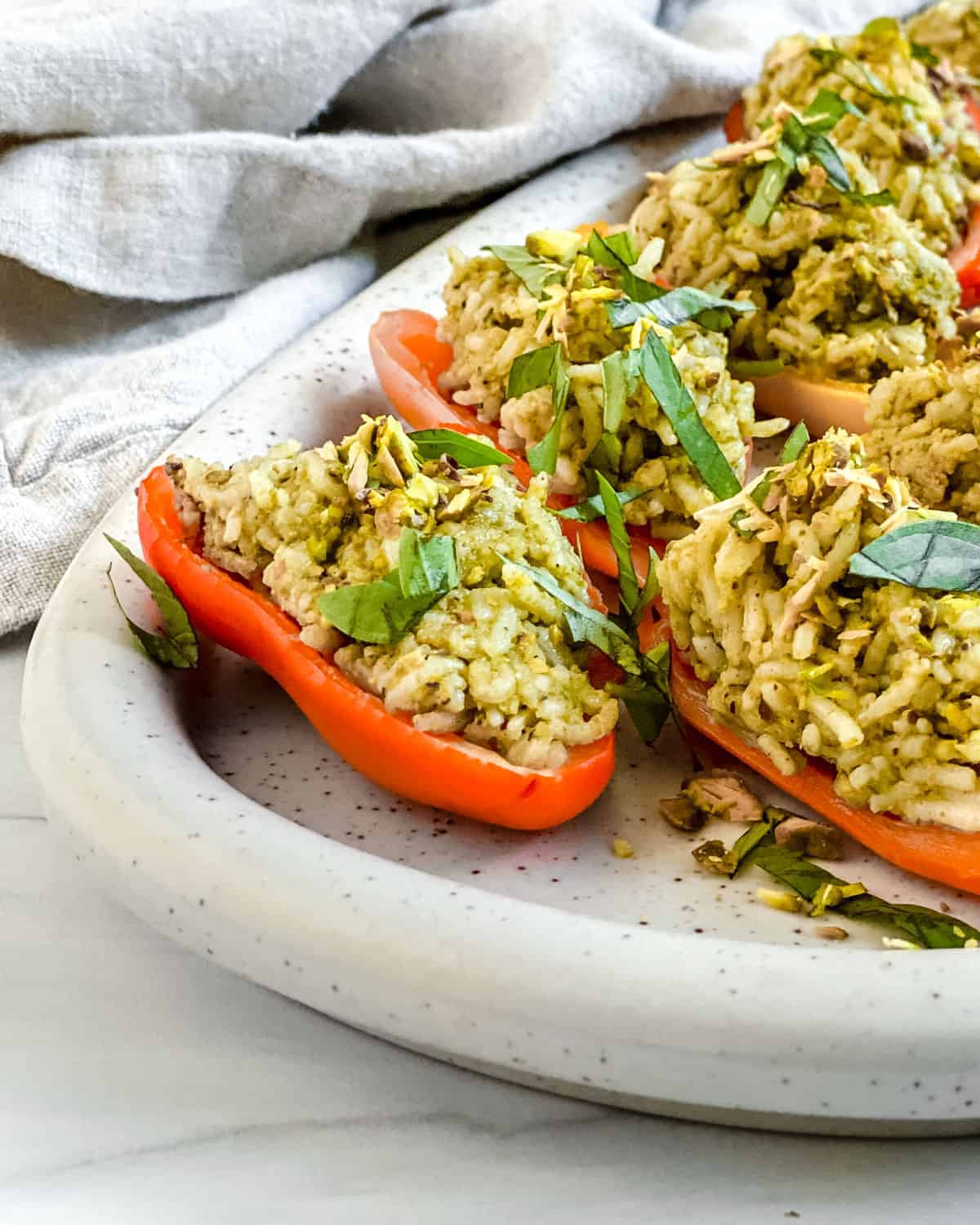 finished Stuffed Roasted Sweet Peppers plated on a white tray