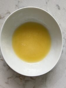 process of melting vegan butter in white bowl