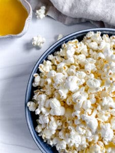 finished Sweet and Salty Popcorn in a blue bowl against a white background