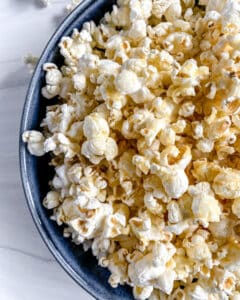 finished Sweet and Salty Popcorn in a blue bowl against a white background