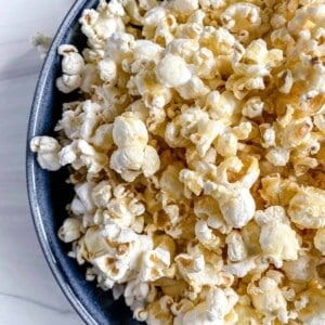 finished Sweet and Salty Popcorn in a blue bowl against a white background