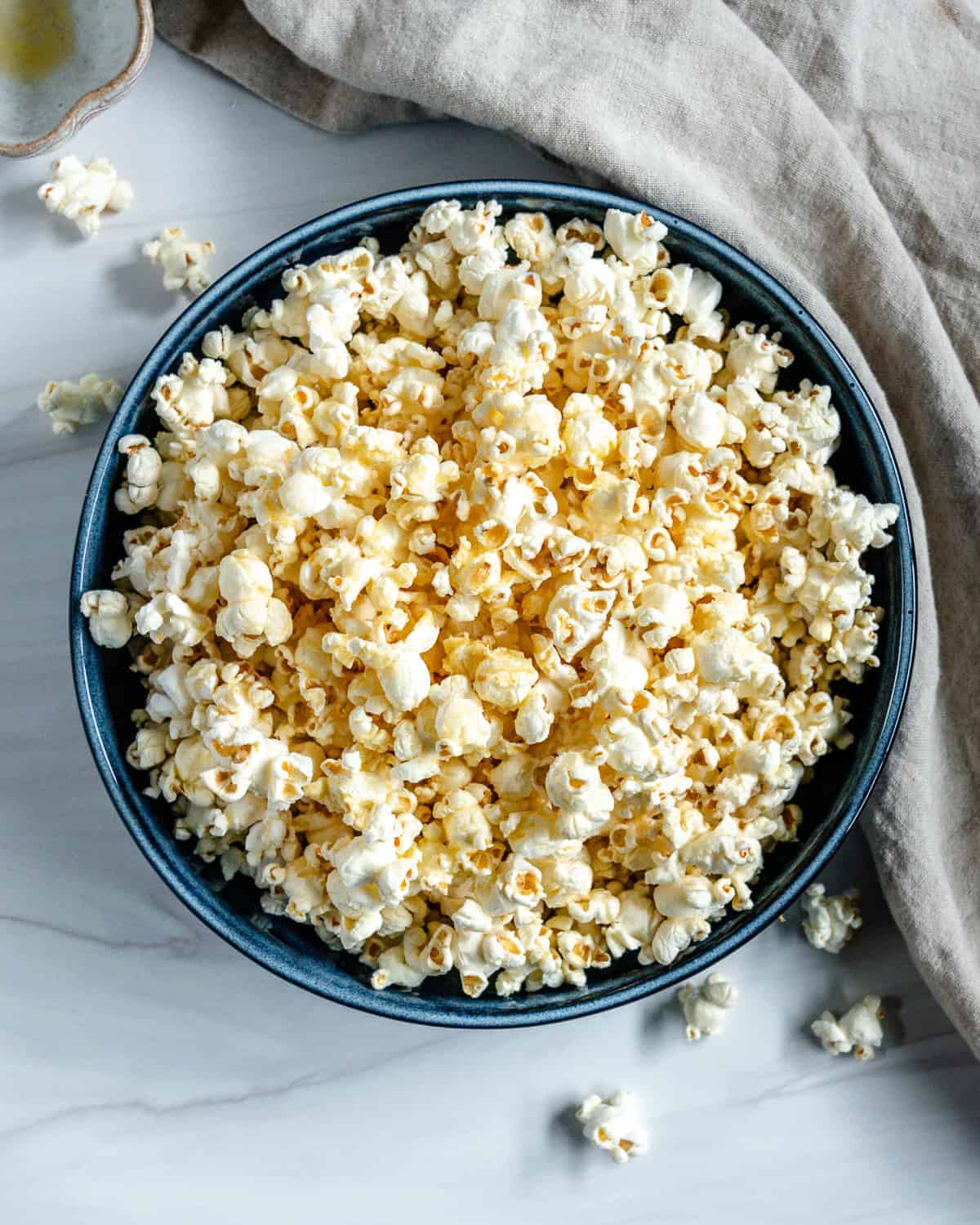 finished Sweet and Salty Popcorn in a blue bowl against a white background