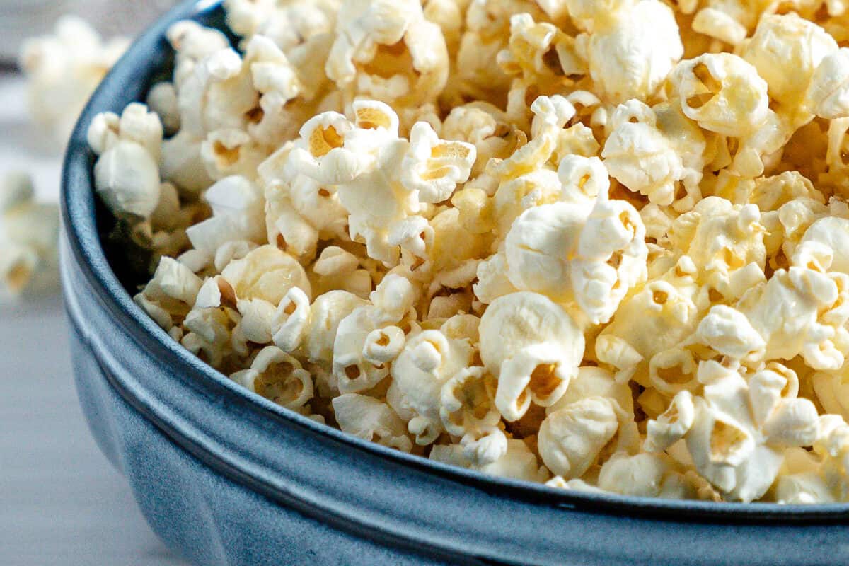 finished Sweet and Salty Popcorn in a blue bowl against a white background