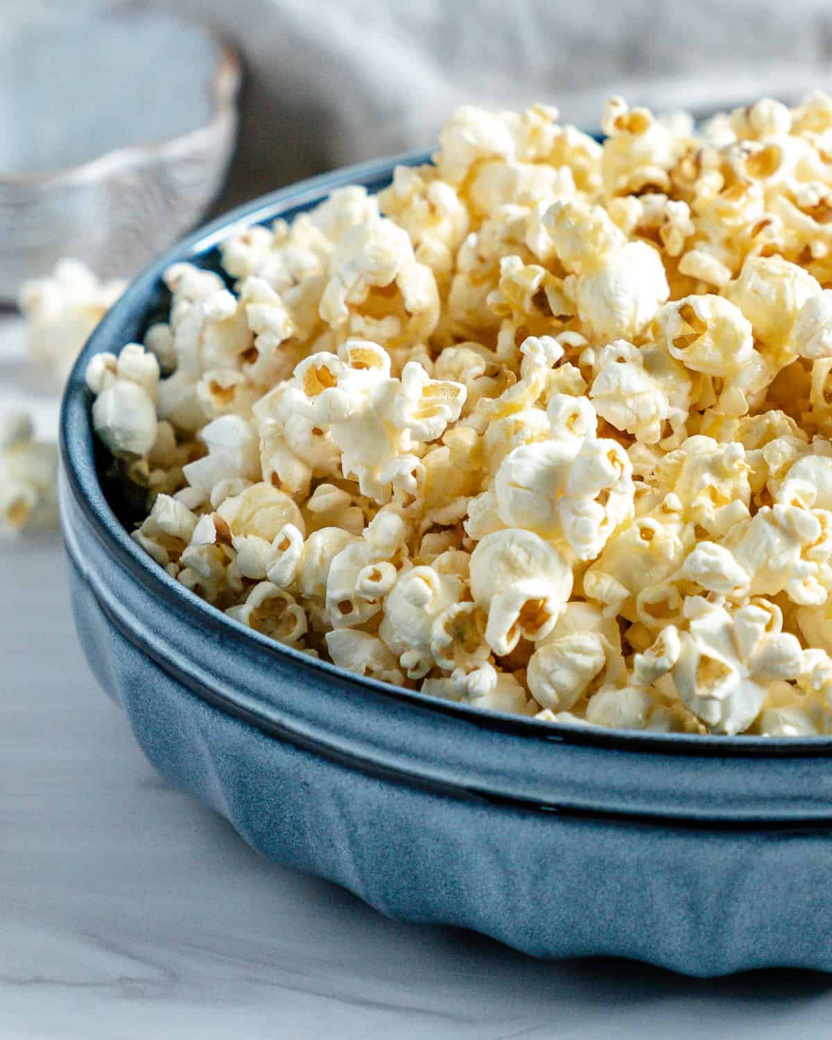 finished Sweet and Salty Popcorn in a blue bowl against a white background