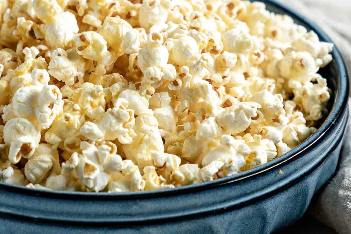 finished Sweet and Salty Popcorn in a blue bowl against a white background