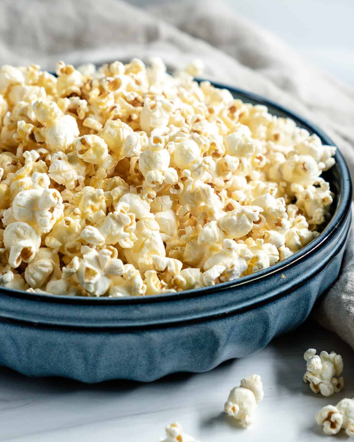 finished Sweet and Salty Popcorn in a blue bowl against a white background