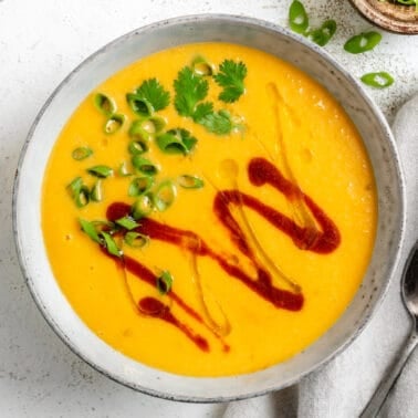 completed Thai Butternut Squash Soup in a white bowl against a white background