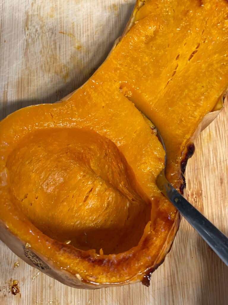 Process shot Scooping butternut squash with a spoon