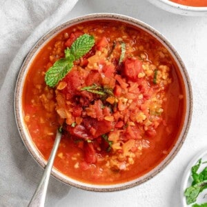 completed Turkish Tomato, Bulgur, and Red Pepper Soup in a bowl against a white surface