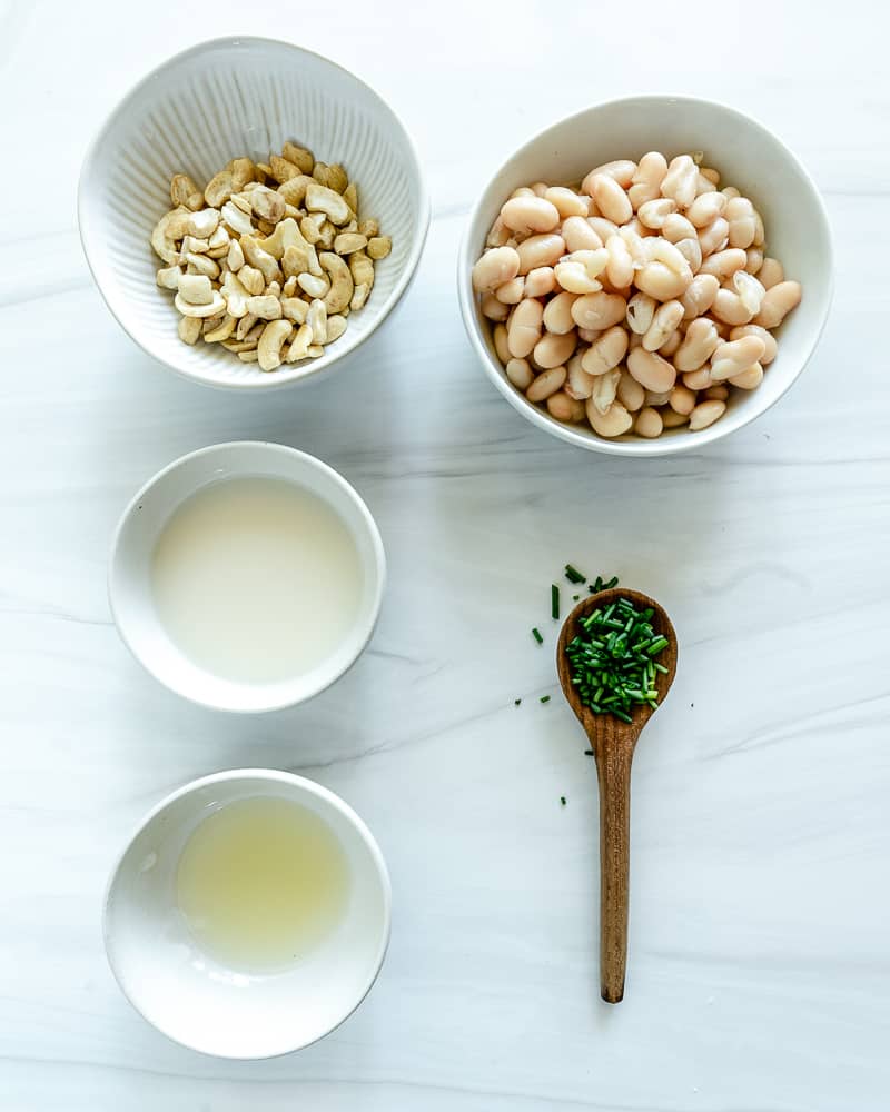ingredients for Cold White Bean Dip with Chives measured out against a white surface