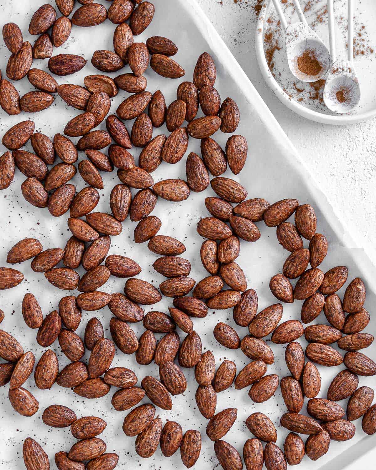 completed cinnamon almonds against a white surface