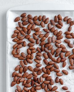 completed cinnamon almonds against a white surface