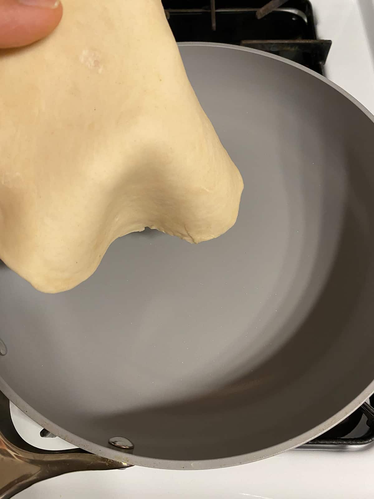 process shot of adding dough to pan