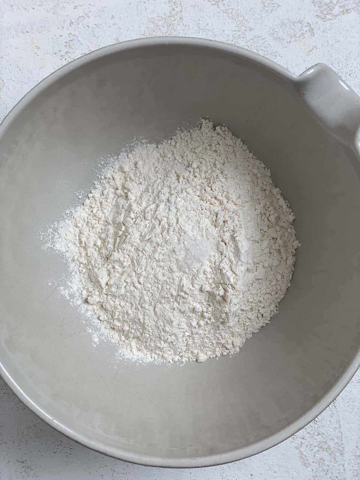 process shot of flour added to bowl