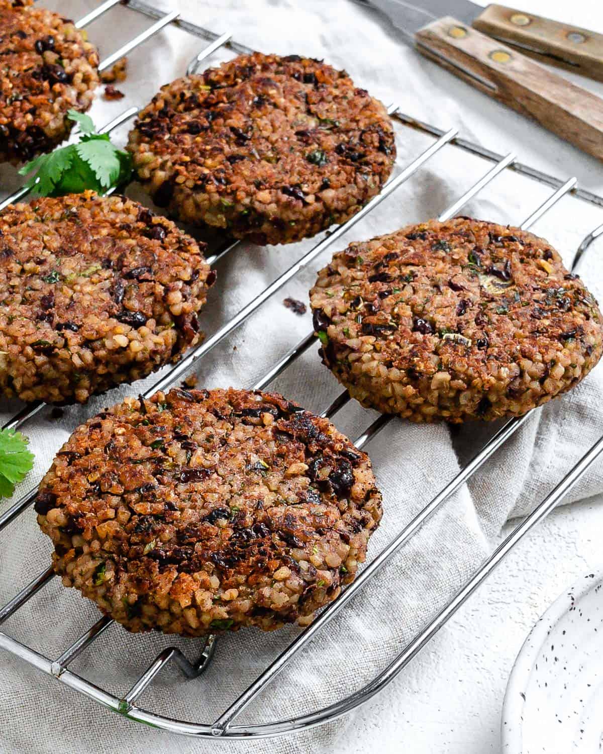 completed Vegan Black Bean and Bulgur Burgers on a wire rack against a light surface