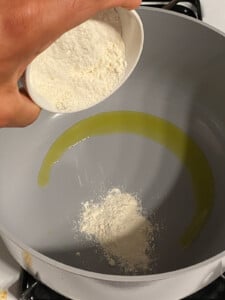 process shot of flour being poured into pan
