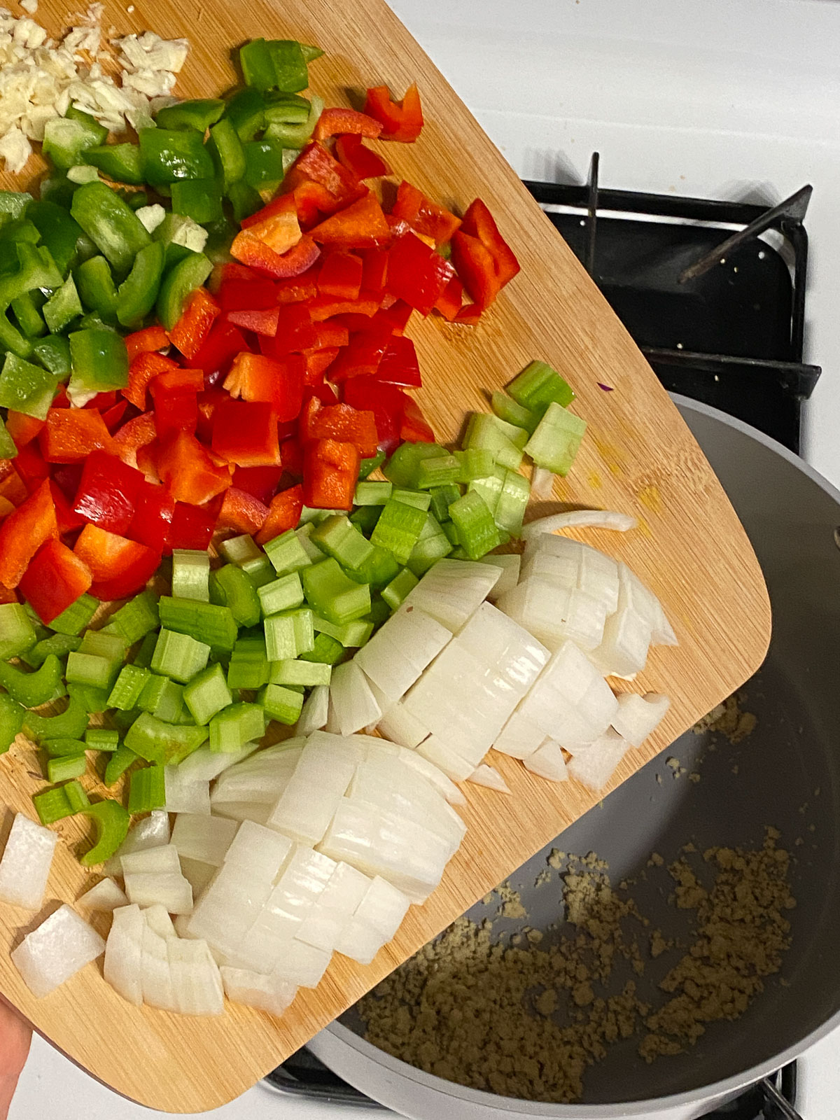 process shot of veggies being poured into pan