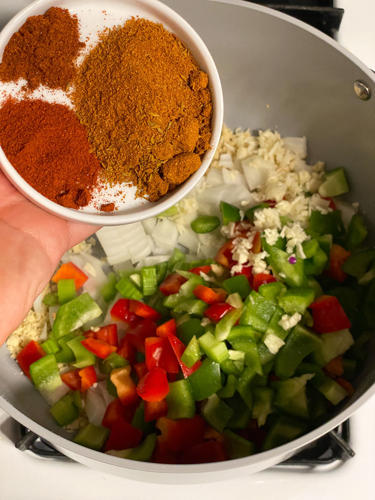 process shot of spices being added into pan