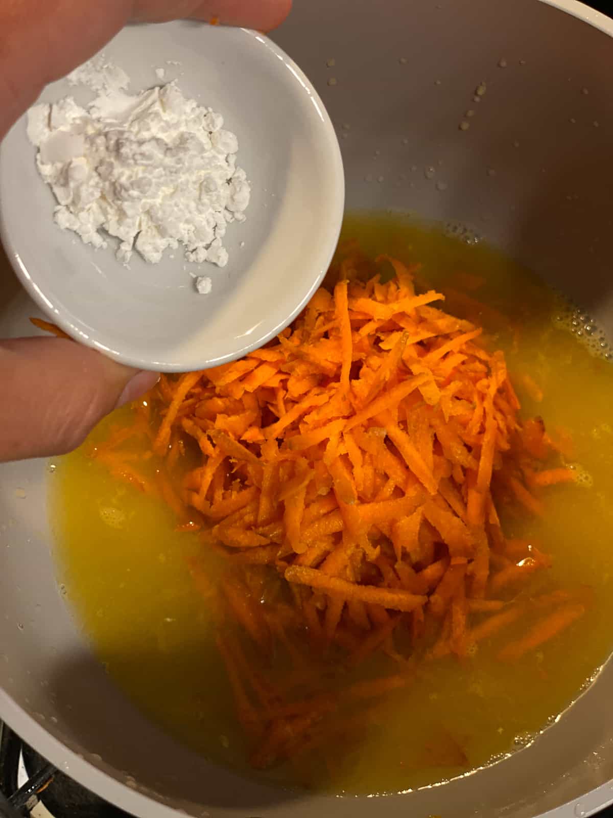 process shot of adding cornstarch to pan