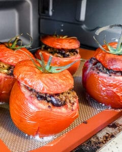 Baked Stuffed Tomatoes on a cookie sheet.