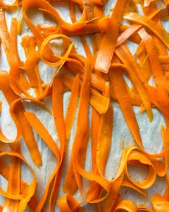 process of placing carrot fries in baking tray 