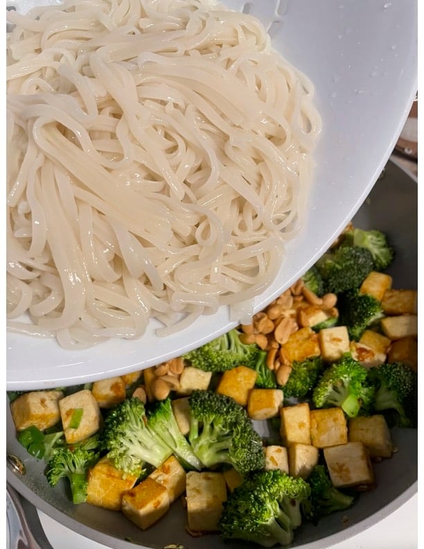 process of adding noodles to pan
