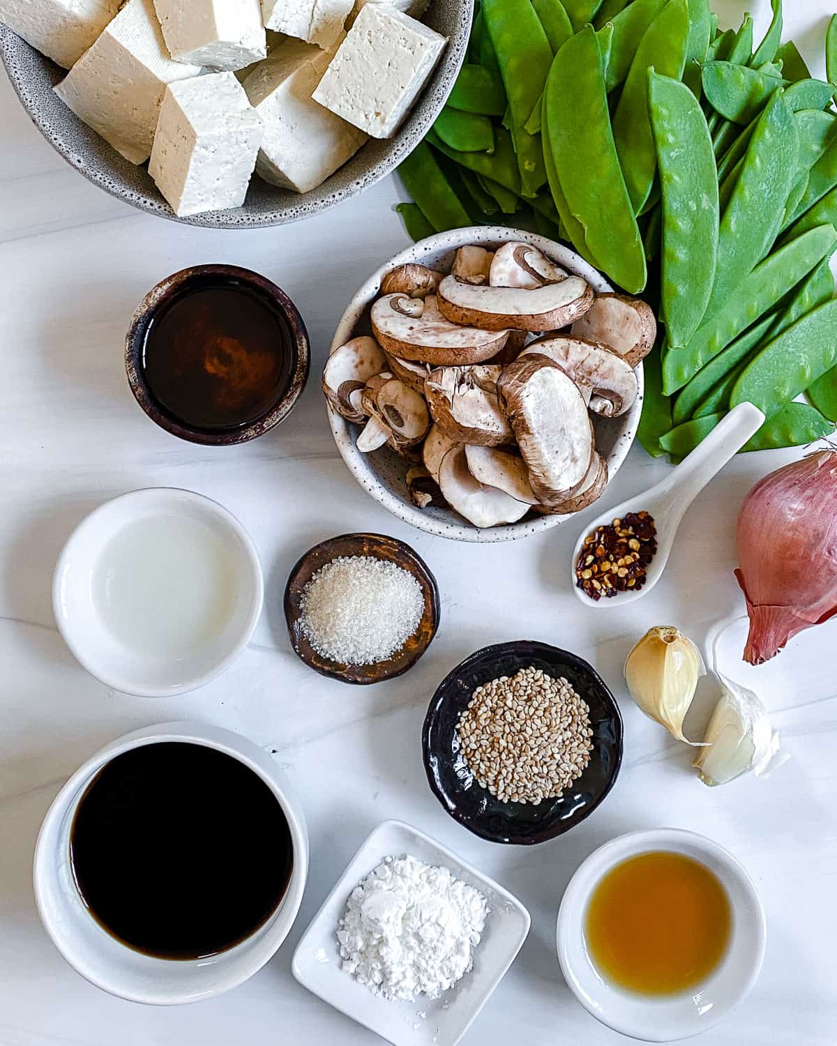 ingredients for Spicy Sesame Tofu Stir-fry measured out on a white surface