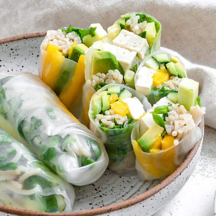 several completed Tofu Spring Rolls With Mango and Avocado plated on a plate