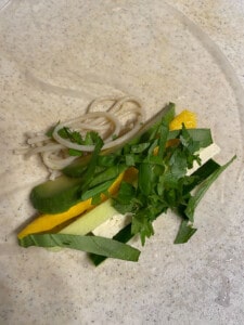 the addition of veggies on the rice wrapper