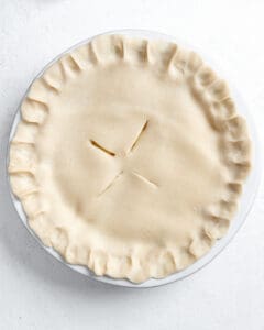 process shot of Vegan Coconut Pineapple Pie before being put in the oven against a white background
