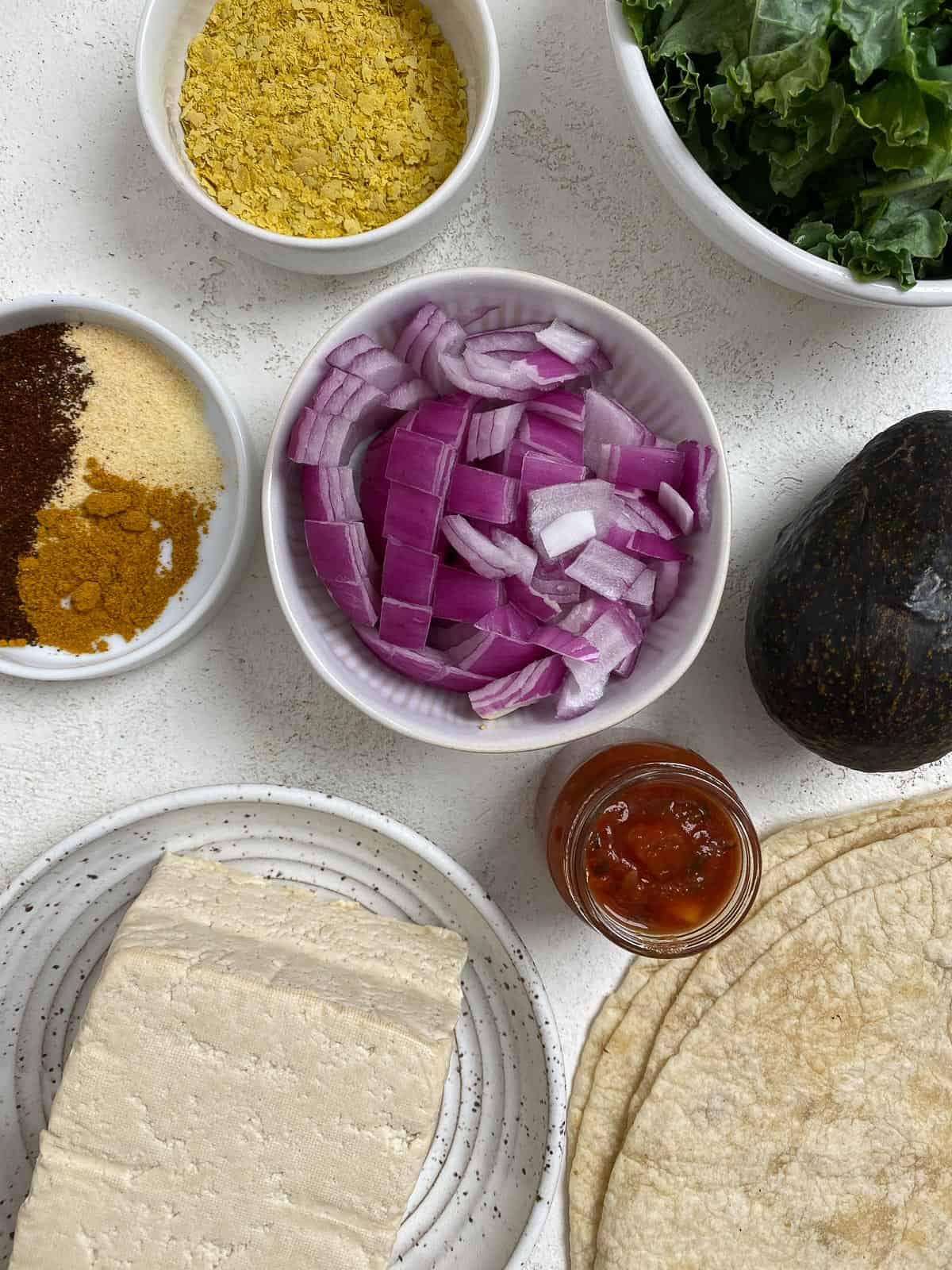 ingredients for Easy Scrambled Tofu Breakfast Burrito measured out against a light surface