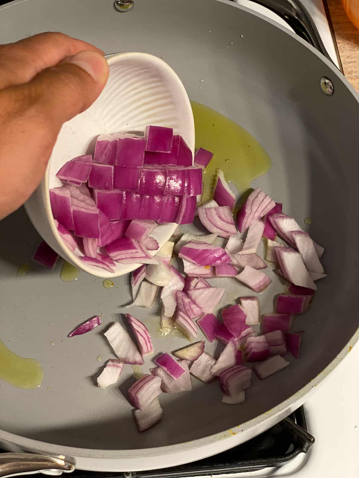 process shot of adding onions to bowl