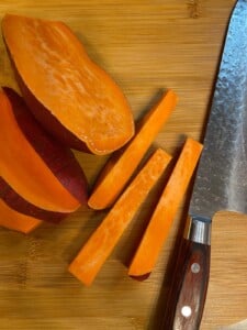 sliced sweet potatoes on a cutting board