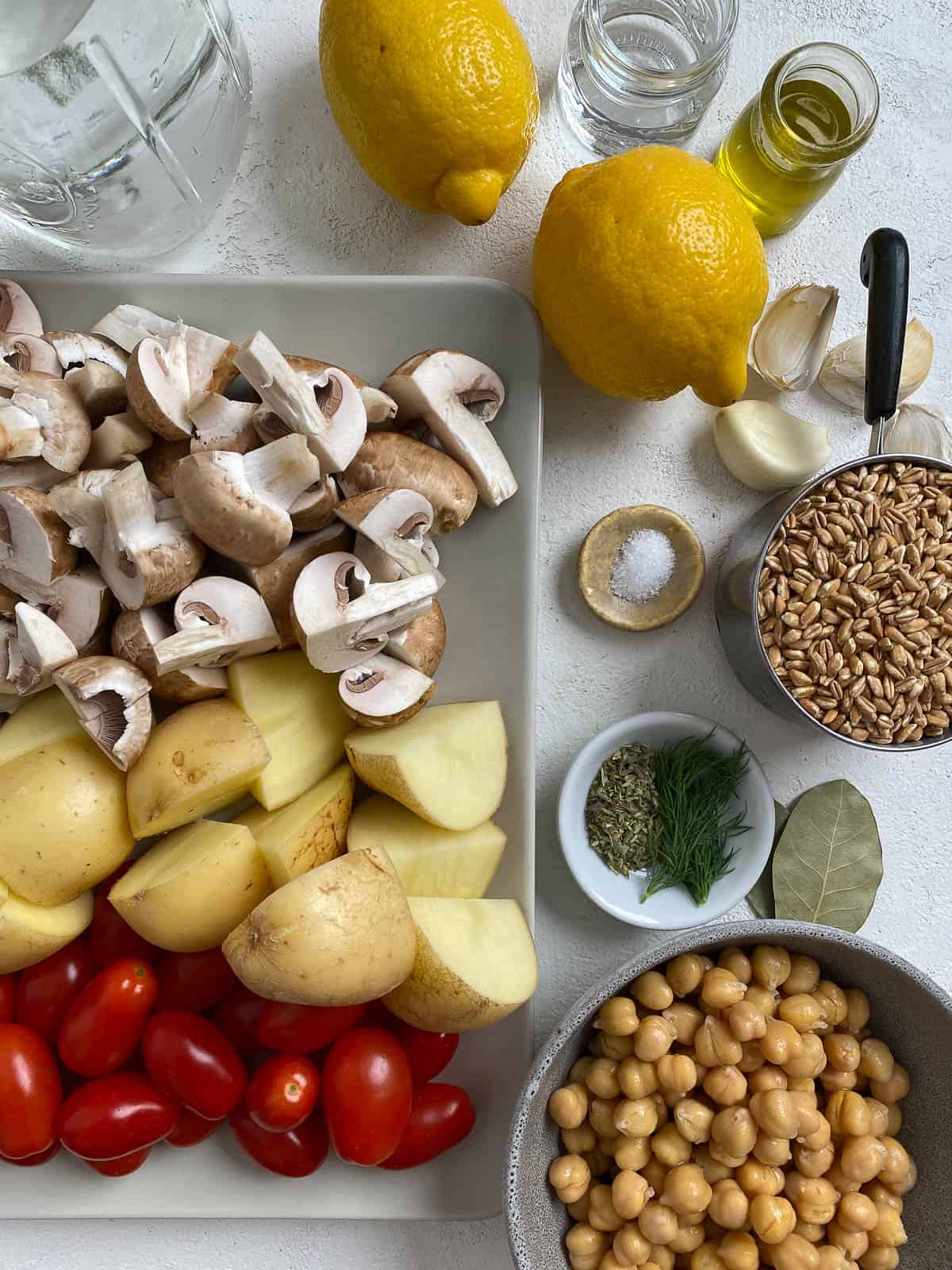 ingredients for Easy Farro Recipe with Roasted Vegetables measured out against a white surface
