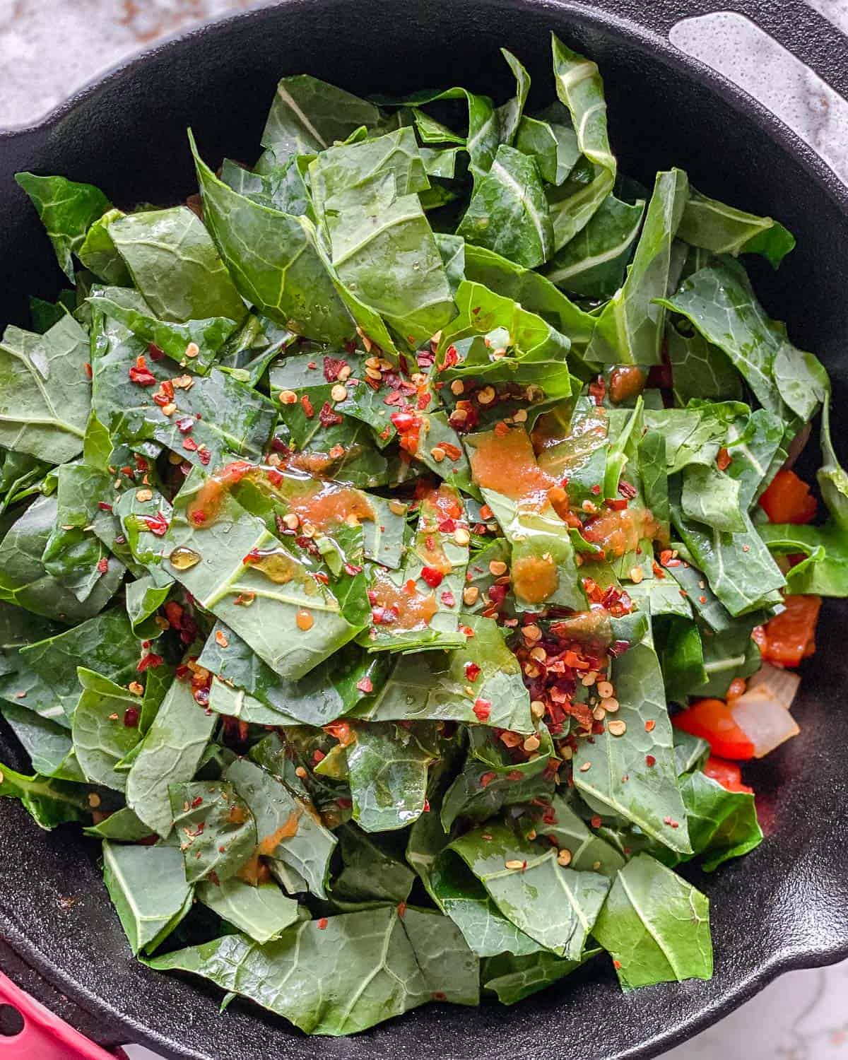 process of adding seasonings to vegetables in black pot