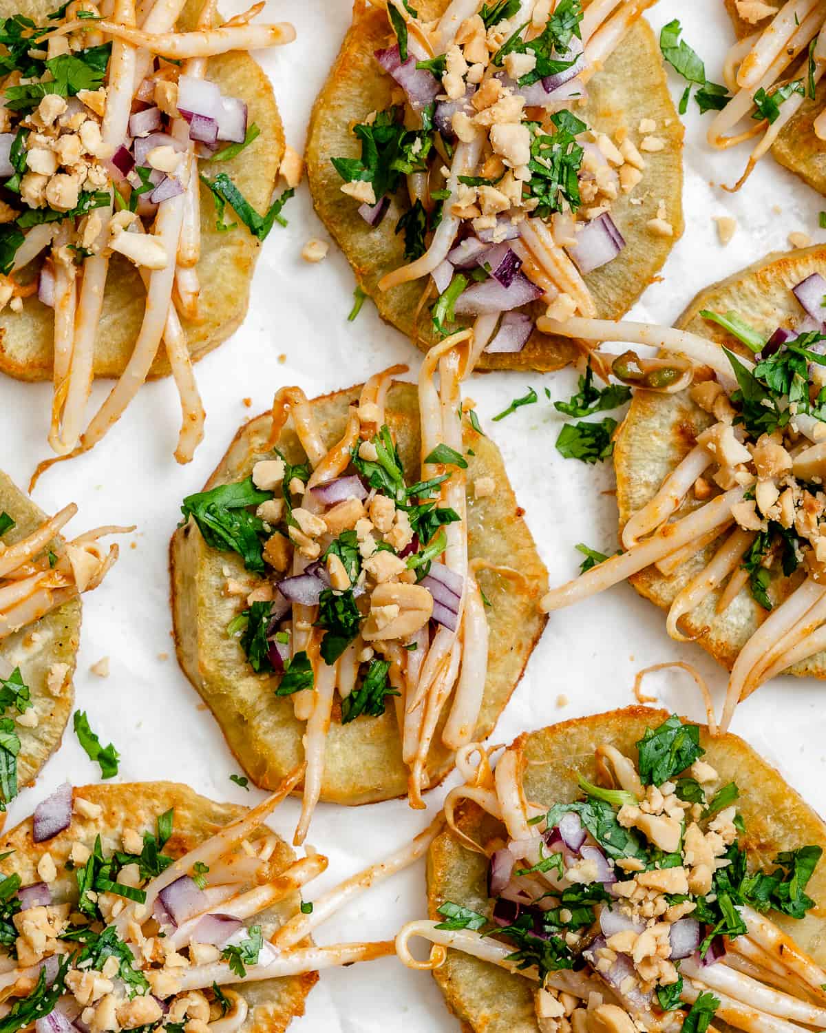 several completed Sweet Potato Bites with BBQ Mung Bean Sprouts against a white surface