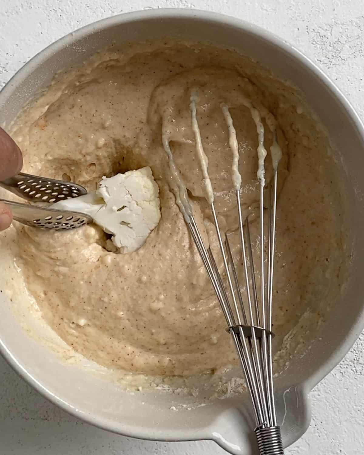 process shot of mixing ingredients to cauliflower batter with mixer