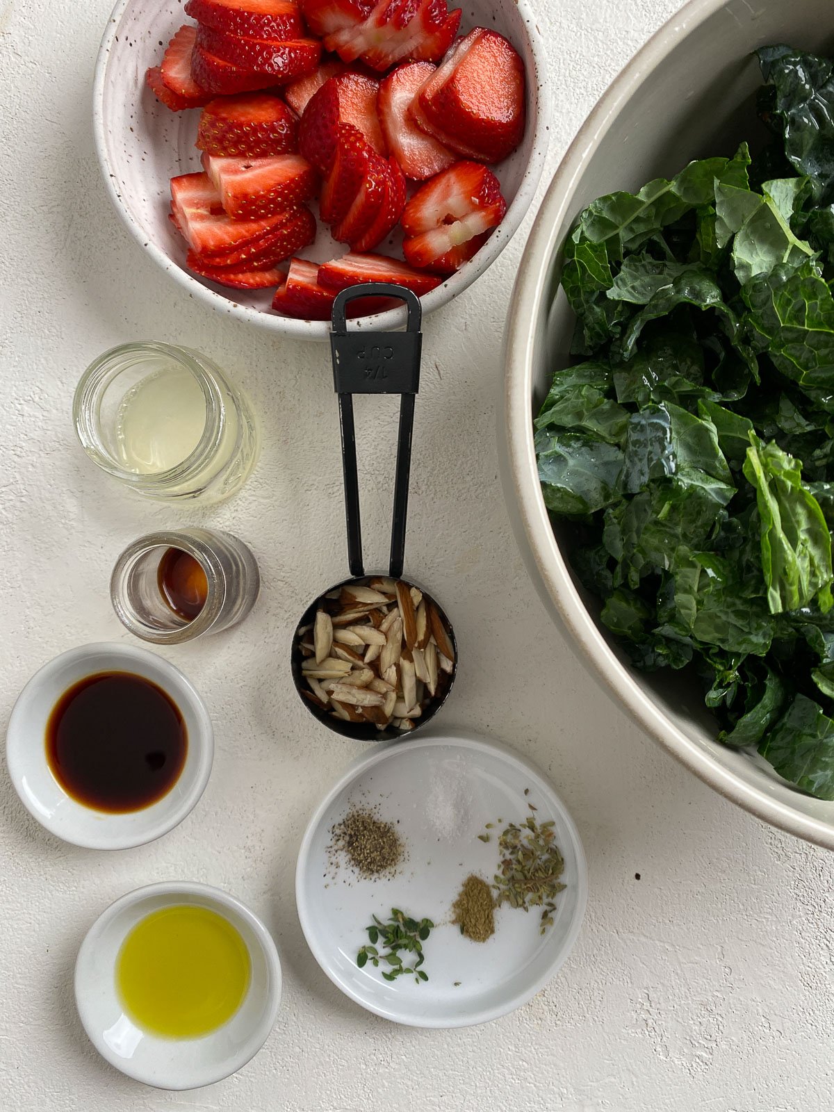 ingredients for Strawberry Kale Salad measured out against a light surface