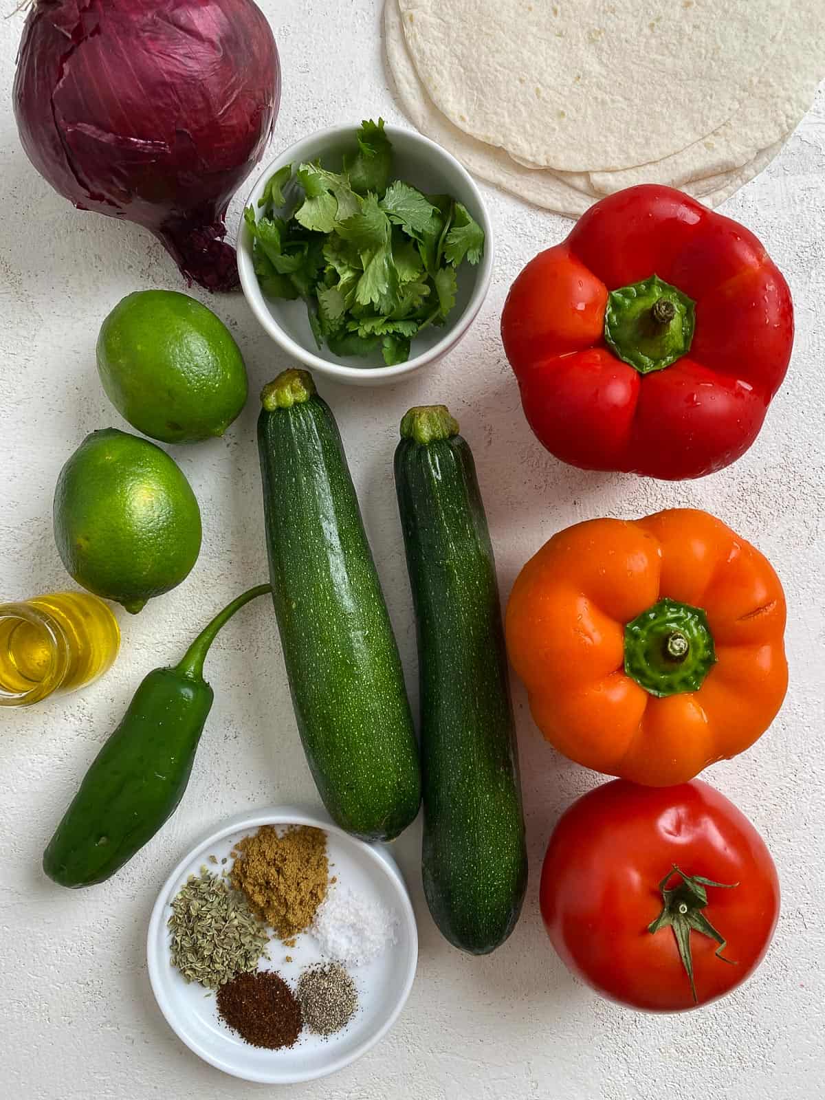 ingredients for Grilled Veggie Fajitas laid out on a white surface
