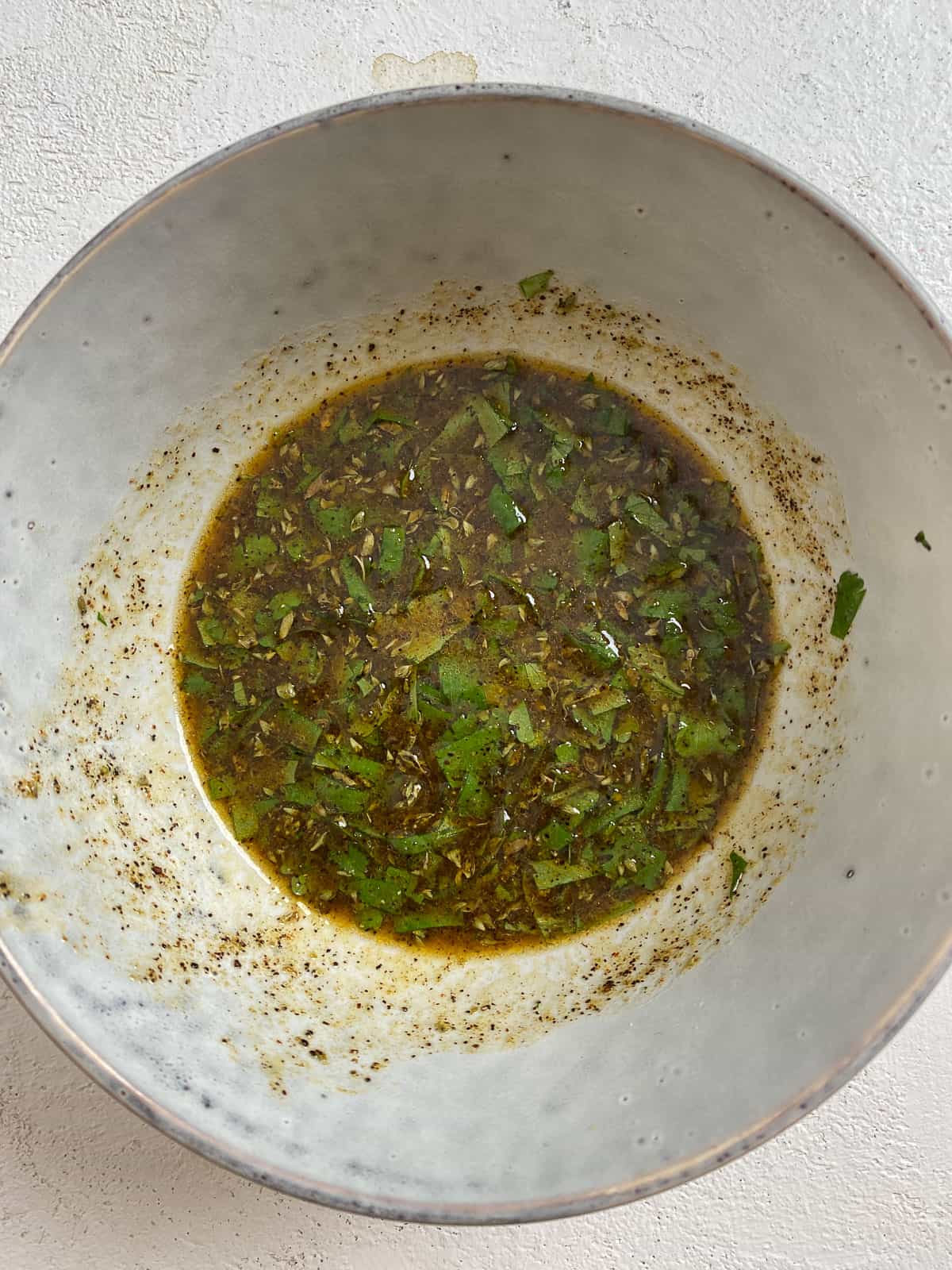 bowl of mixed spices, oil, and lime