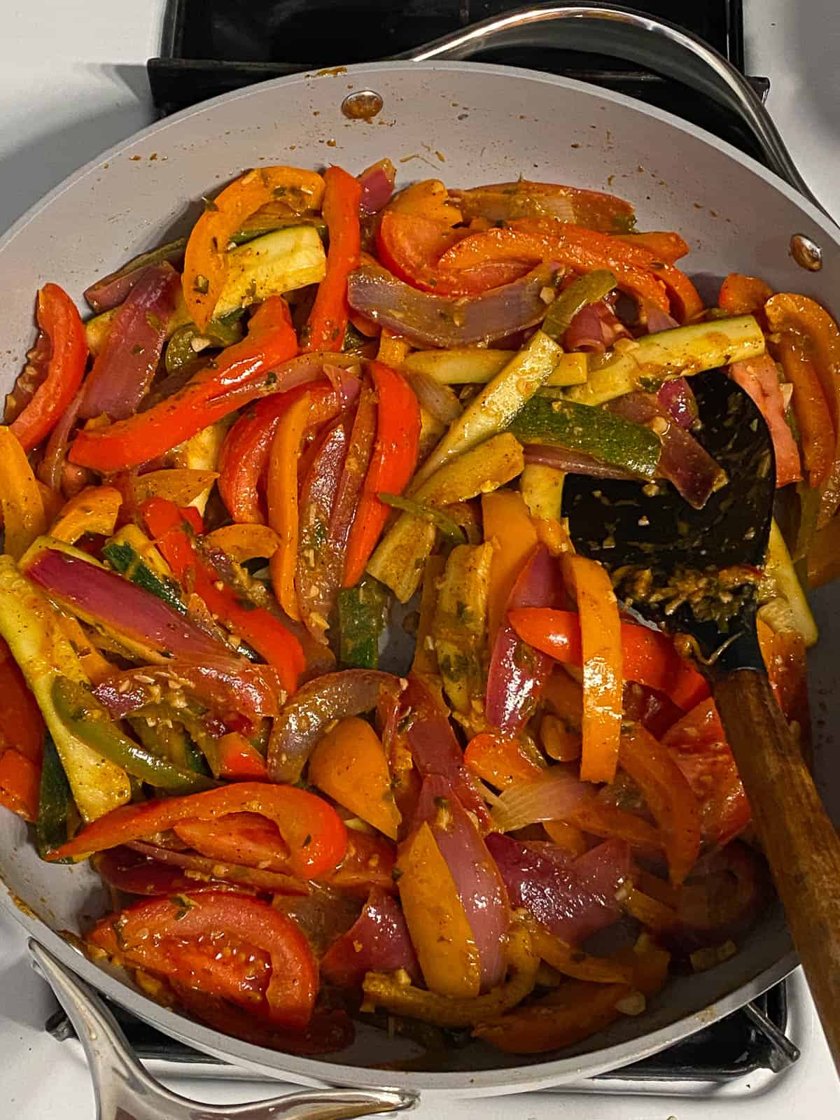 process shot of mixed veggies being cooked in a pan
