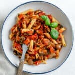 completed Spicy Tomato Basil Pasta in a white plate against a white surface