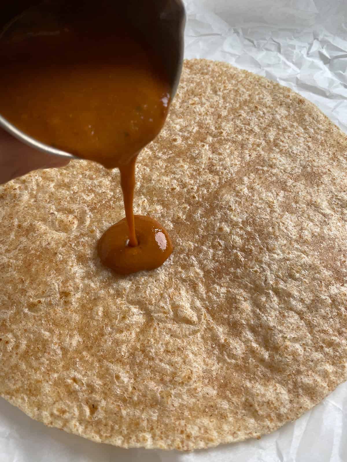 process shot of pouring bbq sauce onto wrap