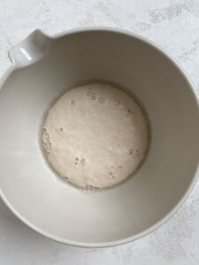 yeast and sugar with water in a white bowl