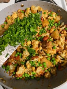 process of adding chopped herbs to pan